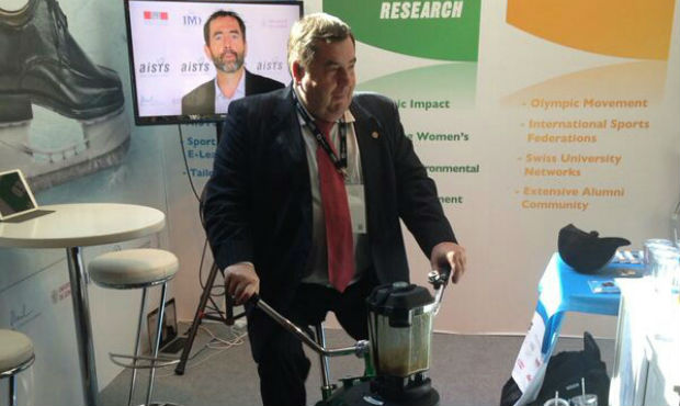 FIAS President Vasily Shestakov cycling at the stand of Inernational Academy of Sports Science and Technology (AISTS) at 2014 SportAccord Convention